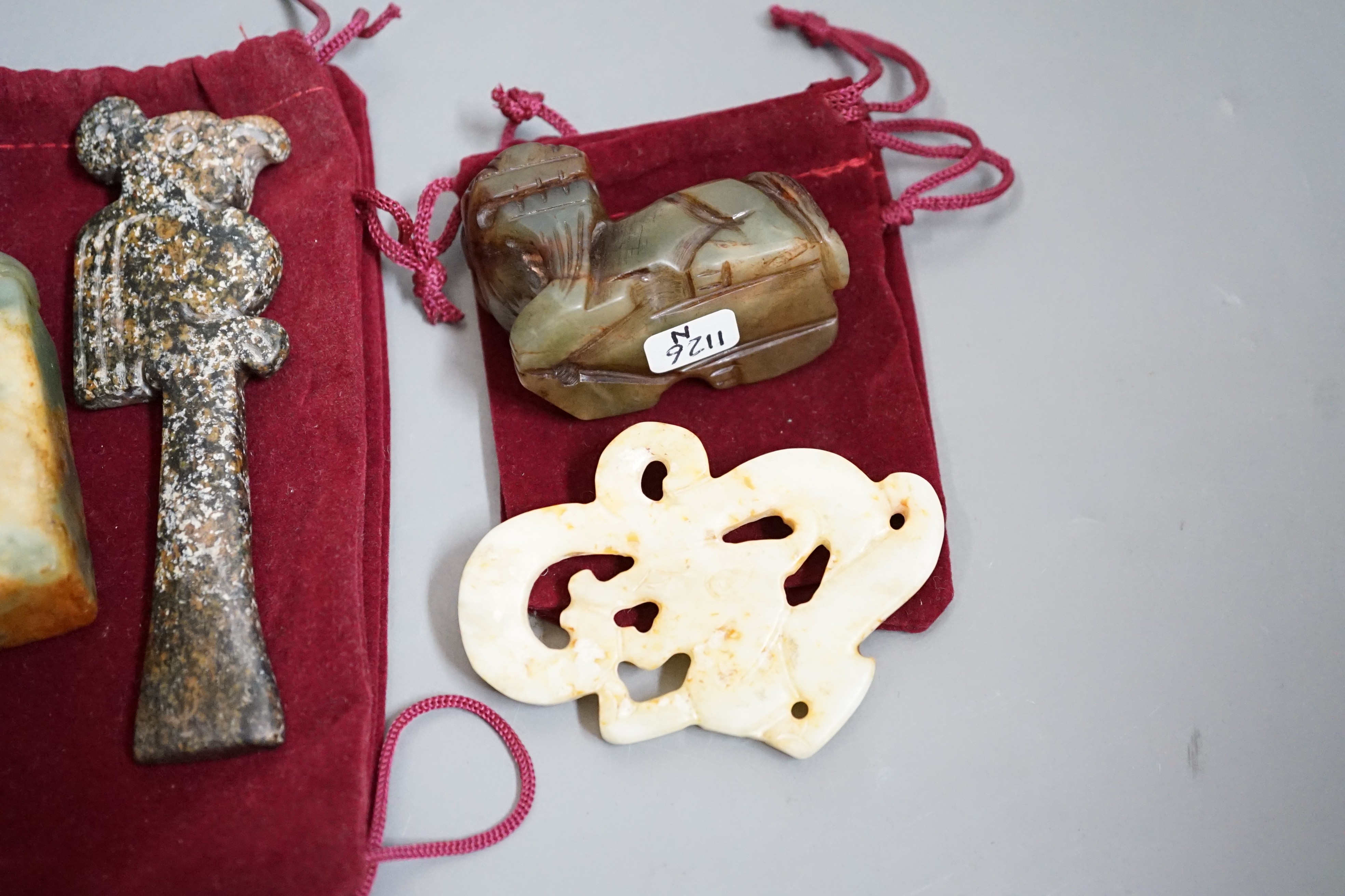 Four jade items: a mythical beast, a seal, a ritual image and a dragon